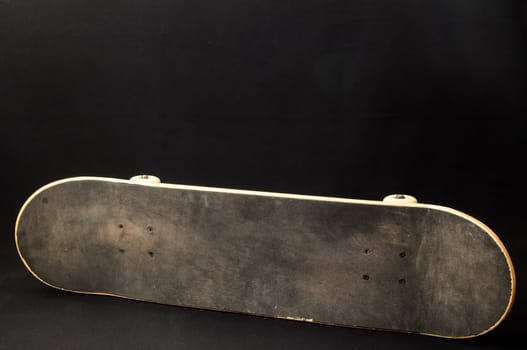 Vintage Style Black Skateboard on a black Background