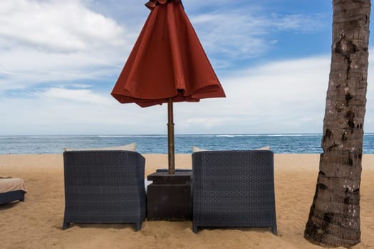 Tropical beach with sun lounger and umbrellas with white sand in the Caribbean