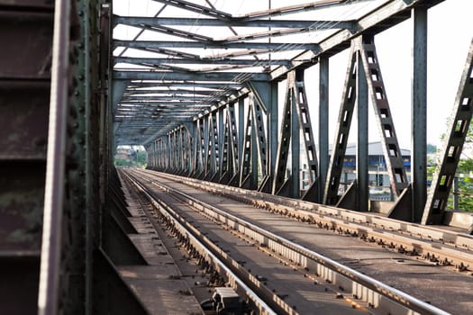 Abandoned bridge with rails for train traffic in daylight