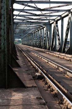 Abandoned bridge with rails for train traffic in daylight