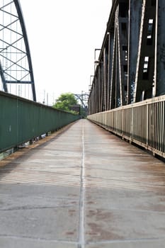 Abandoned bridge with rails for train traffic in daylight