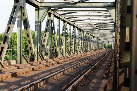 Abandoned bridge with rails for train traffic in daylight