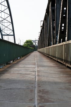 Abandoned bridge with rails for train traffic in daylight