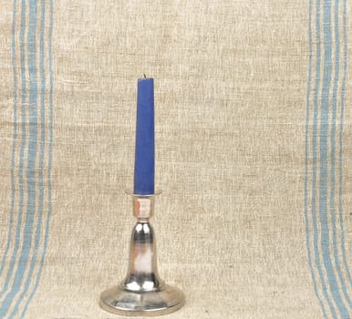 Candlestick on linen background