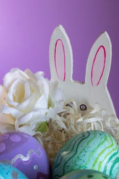 Easter eggs , flowers and funny bunny to celebrate Easter. Wallpaper for Easter announcements and cards.Vertical real picture, ideal for social media stories and postings