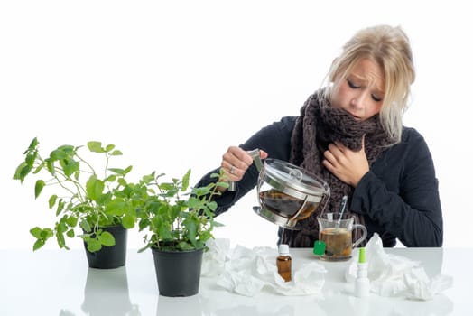 Sick blonde woman drinks herbal tea