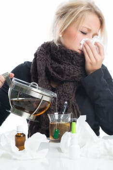 Sick blonde woman drinks herbal tea