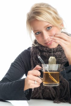 Sick blonde woman drinks herbal tea