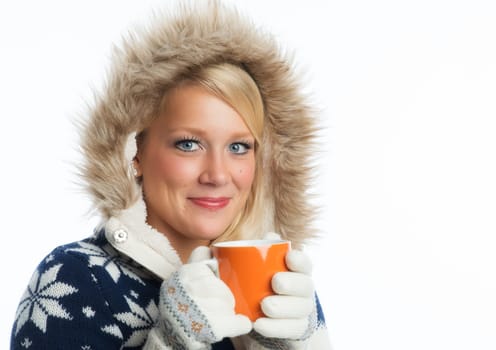 Blonde woman drinks from a mug