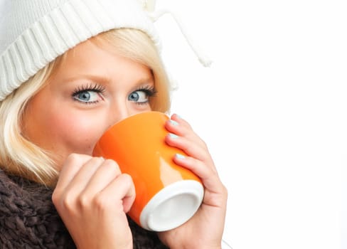 Blonde woman drinks from a mug