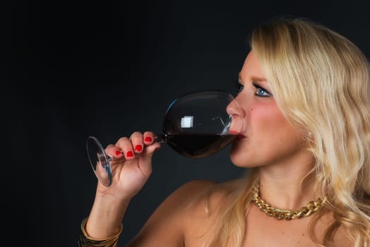 Elegant woman with red wine in glass