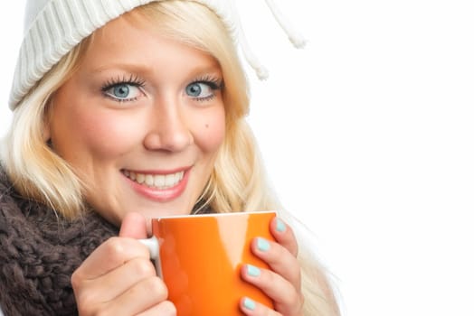 Blonde woman drinks from a mug