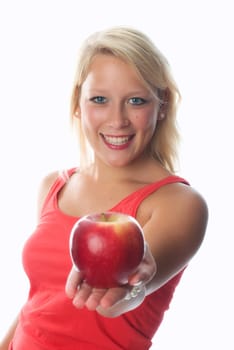 Blonde woman holds a red apple