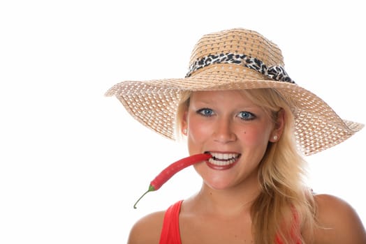 Woman bites in chilli pepper
