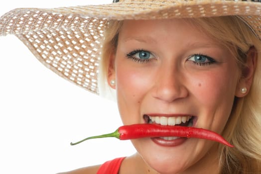 Woman bites in chilli pepper