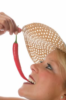 Woman bites in chilli pepper