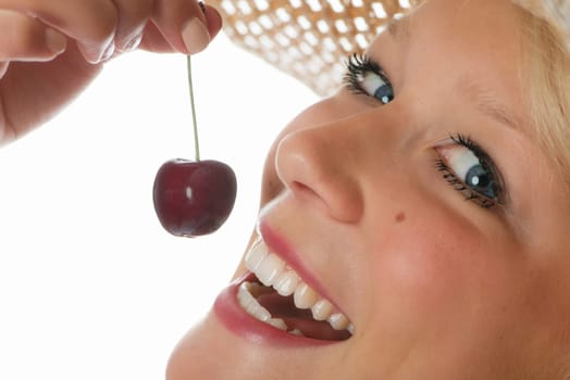 Blonde woman eats cherry
