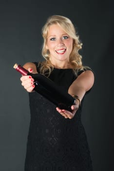 Beautiful blonde woman with red wine bottle