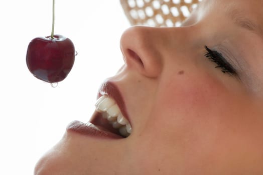 Woman eats cherry