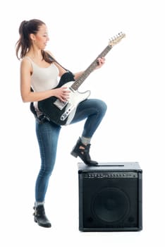 Young girl with electric guitar and amplifier
