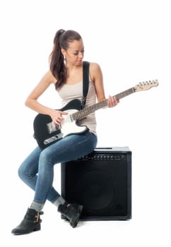 Young girl with electric guitar and amplifier