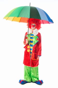 Sad clown with umbrella