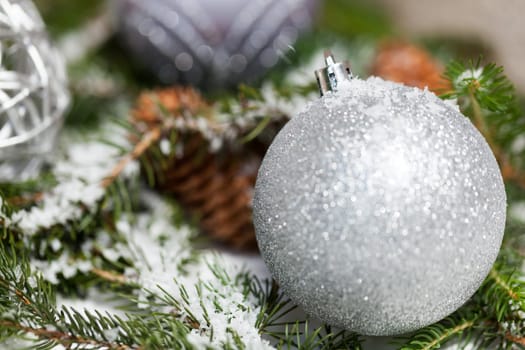 Silver Christmas bauble jewelry with deer and fir branches decoration for Christmas as macro detail