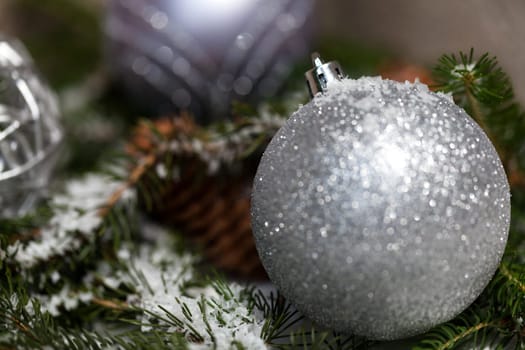 Silver Christmas bauble jewelry with deer and fir branches decoration for Christmas as macro detail