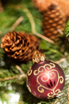 red Christmas tree ornament sembrightly decoration for Christmas with golden ornaments as macro detail