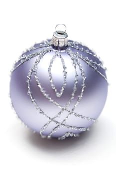 Glittering silver Christmas bauble on white background Macro detail