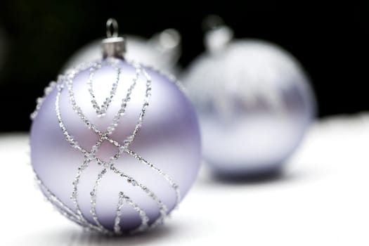 Glittering silver Christmas bauble on white background Macro detail