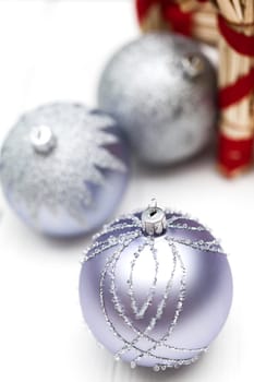 Glittering silver Christmas bauble on white background Macro detail