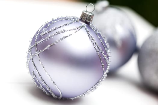 Glittering silver Christmas bauble on white background Macro detail