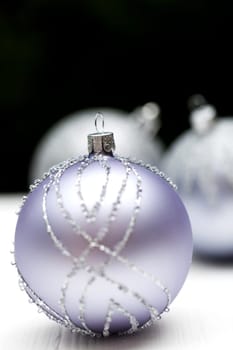 Glittering silver Christmas bauble on white background Macro detail