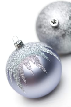 Glittering silver Christmas bauble on white background Macro detail