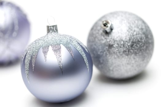 Glittering silver Christmas bauble on white background Macro detail
