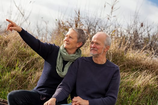 happy relaxed older couple out in the natural senior pensioner's leisure health old