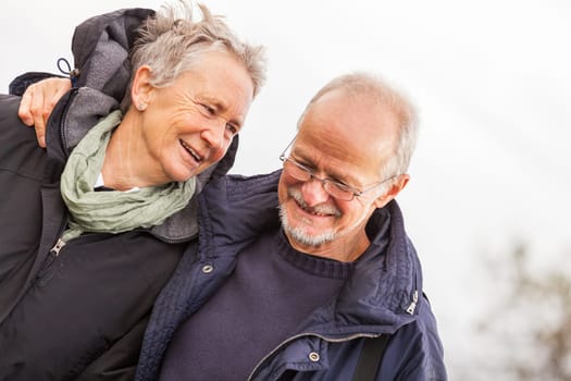 older happy couple makes a beach walk in autumn baltic sea landscape sea