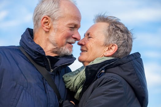 older seniors couple happy laughing in holiday leisure natural ostsee