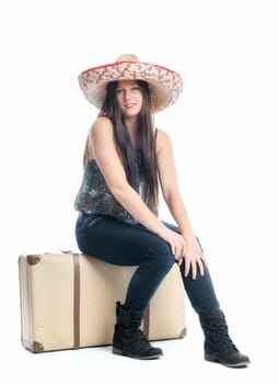 Girl sits on suitcase