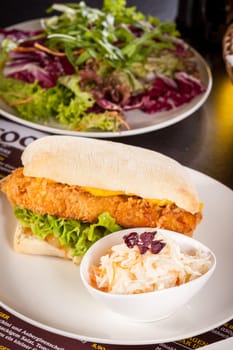 Chickenburger with chicken meat and salad as a close-up on a plate