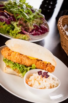 Chickenburger with chicken meat and salad as a close-up on a plate