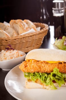 Chickenburger with chicken meat and salad as a close-up on a plate
