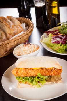 Chickenburger with chicken meat and salad as a close-up on a plate