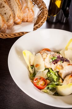 Fresh delicious caesarsalat with grilled chicken bust parmesan splinters and croutons