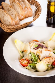 Fresh delicious caesarsalat with grilled chicken bust parmesan splinters and croutons