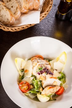 Fresh delicious caesarsalat with grilled chicken bust parmesan splinters and croutons