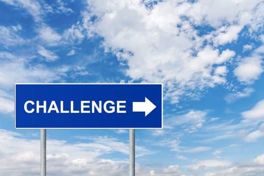 challenge on blue road sign with blue sky