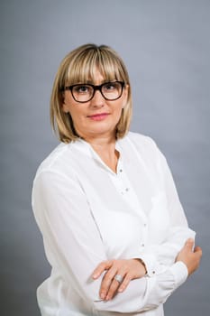 attractive adult woman in middle age with white blouse and brille