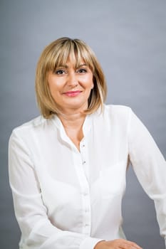 adult attractive woman in middle age portrait against gauem background